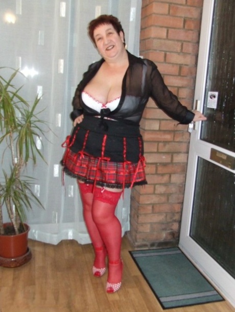 Fat amateur with short hair Kinky Carol exposes her huge tits in red nylons