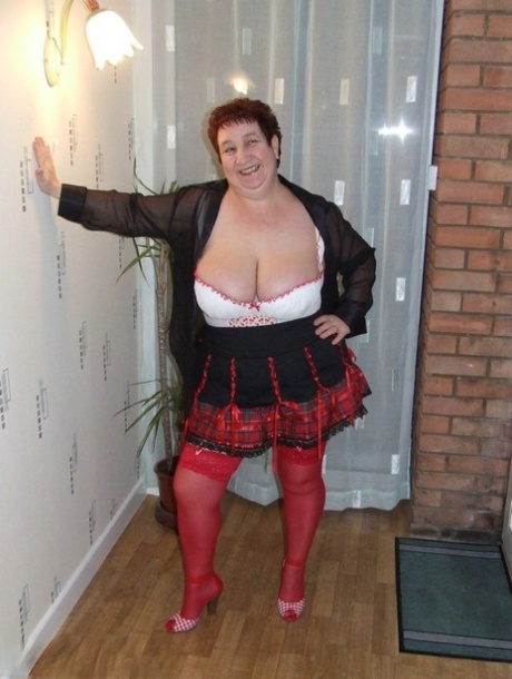 Fat amateur with short hair Kinky Carol exposes her huge tits in red nylons