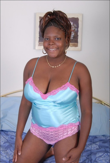 Black plumper frees her big natural tits from satin lingerie as she gets naked