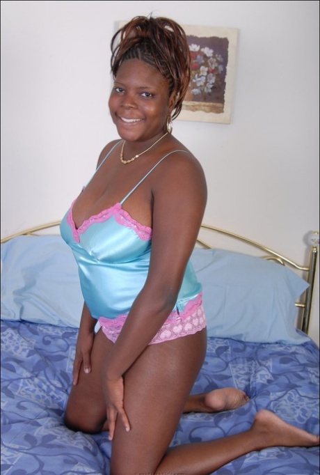 Black plumper frees her big natural tits from satin lingerie as she gets naked