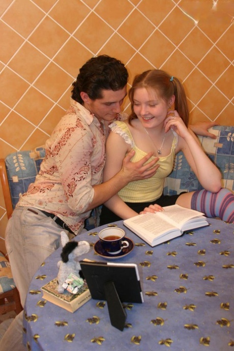 Young looking redhead takes it up the ass in long socks and pigtails