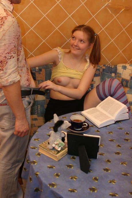 Young looking redhead takes it up the ass in long socks and pigtails