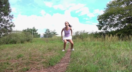 Thin girl Mistika takes a piss on a path while walking through the countryside