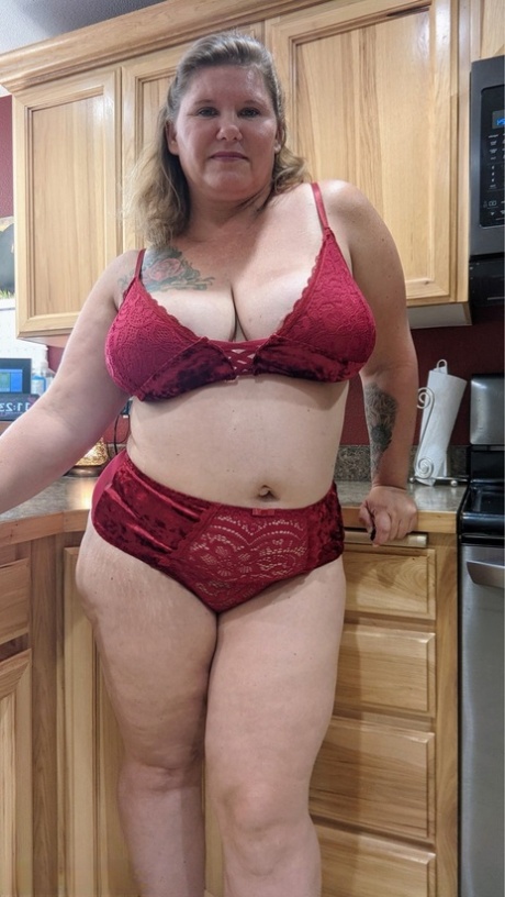 Amateur woman Busty Kris Ann shows her big tits and butt in her kitchen