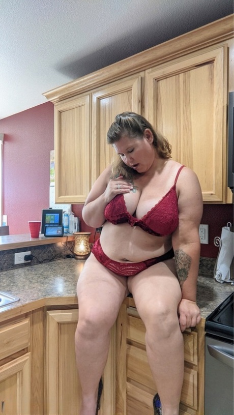 Amateur woman Busty Kris Ann shows her big tits and butt in her kitchen