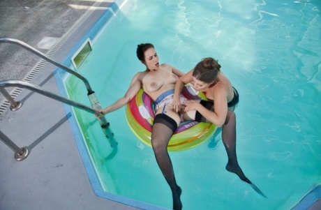 Antonia and Lady Lyne have lesbian sex in a pool while wearing nylons
