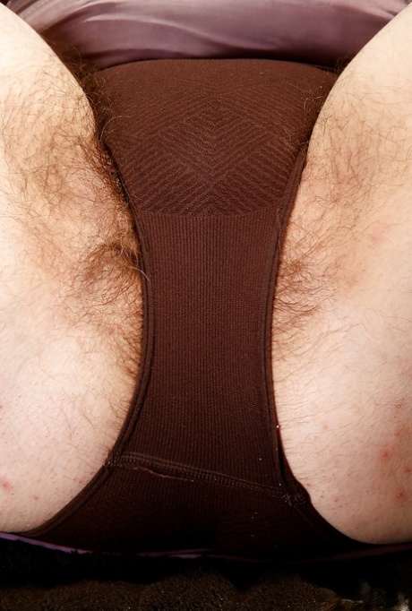 Mature fatty with hairy legs freeing big tits and beaver from underthings