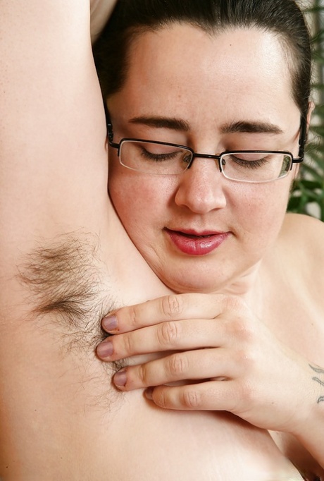 Mature plumper in glasses baring big breasts and hairy vagina