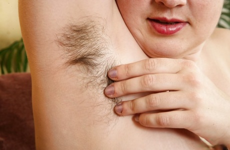 Mature plumper in glasses baring big breasts and hairy vagina