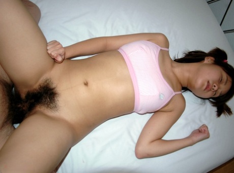Tiny Japanese babe sucks dick & gets her hairy pussy fucked in the bedroom