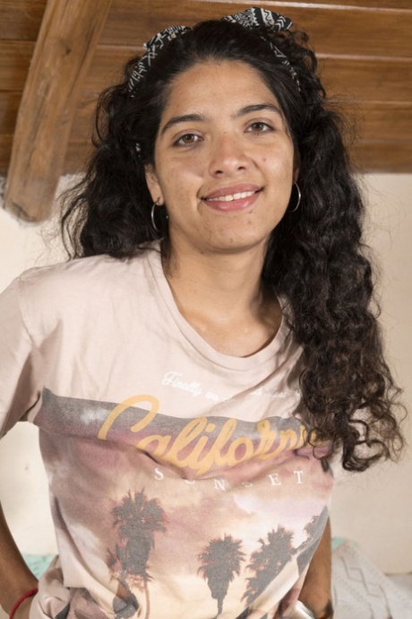 Lovely Maria F strips and plays with her long pussy hair on the bed
