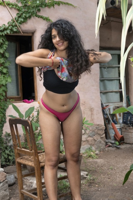 Amateur sweetie Maria F shows her saggy tits and rubs her bushy twat outside