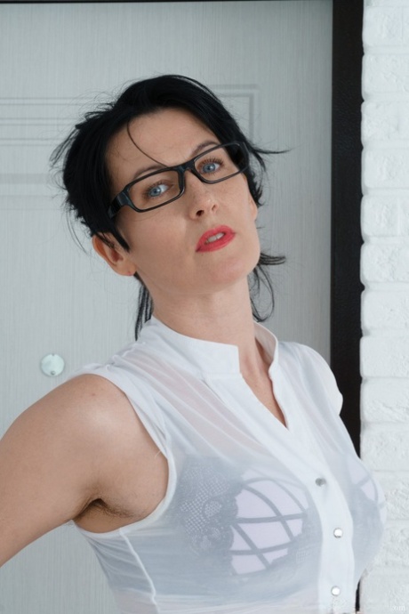 Naughty mom in glasses Nimfa Mannay presents her hairy twat in a solo