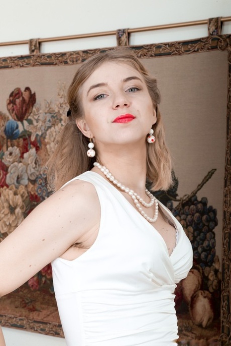 Red-lipped & elegant Kristinka strips naked to flaunt hairy armpits & beaver