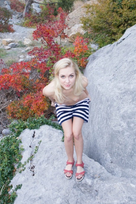 Skinny blonde Felicia stripping & showing off her furry muff on rocky mountain