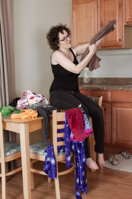 Nasty amateur geek Tamar shows juicy tits and fuzzy coochie in the kitchen