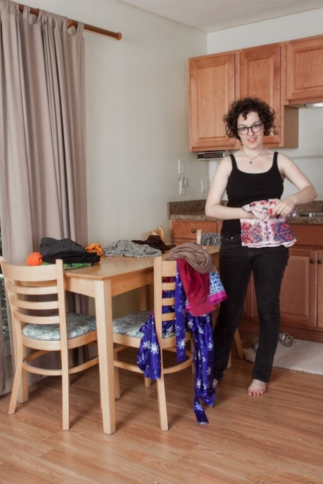 Nasty amateur geek Tamar shows juicy tits and fuzzy coochie in the kitchen