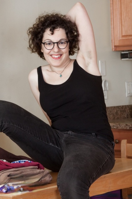 Nasty amateur geek Tamar shows juicy tits and fuzzy coochie in the kitchen