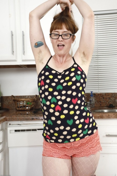 Mature housemaid Thelma Sleaze shows her very hairy pussy in the kitchen