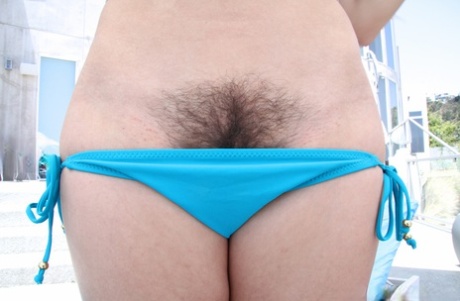 Sexy brunette girl with a hairy muff Dani Daniels takes a dong on a couch