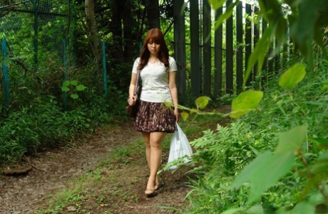 Asian brunette Eri Makino plays with her big juggs and gets fucked outdoors