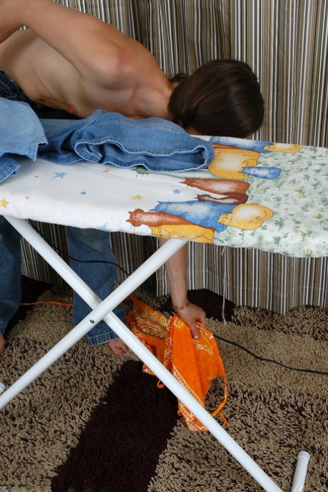 Brunette teen Maddy removes her clothes & shows her hairy pussy while ironing