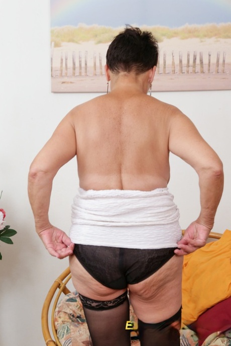 Luscious granny Heidi strips to her nylon stockings & toys her mature twat