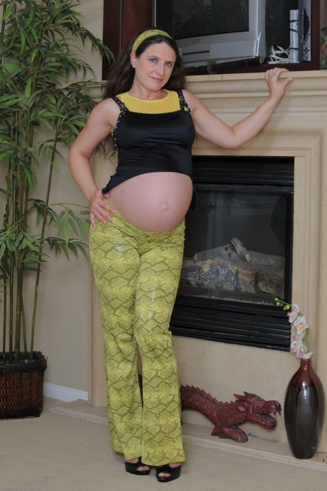Pregnant amateur teen Angela fingers her hairy pussy & ass by the fireplace