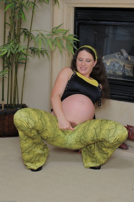 Pregnant amateur teen Angela fingers her hairy pussy & ass by the fireplace