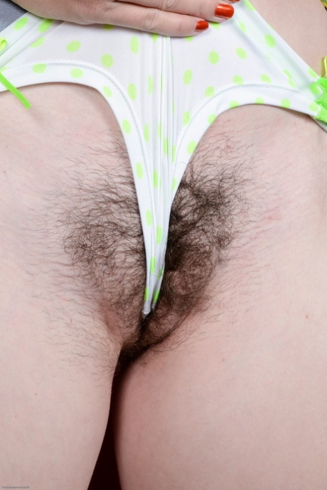Pigtailed amateur teen Lara Brookes playing with her puffy hairy pussy