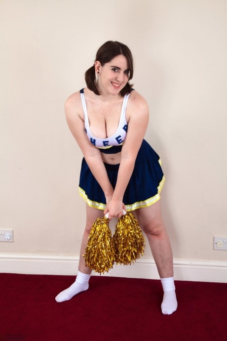 Chubby cheerleader Beryl Aspen unveils her big tits and furry vagina