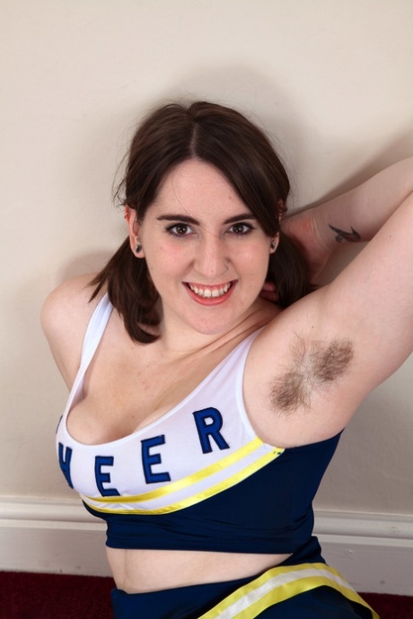 Chubby cheerleader Beryl Aspen unveils her big tits and furry vagina