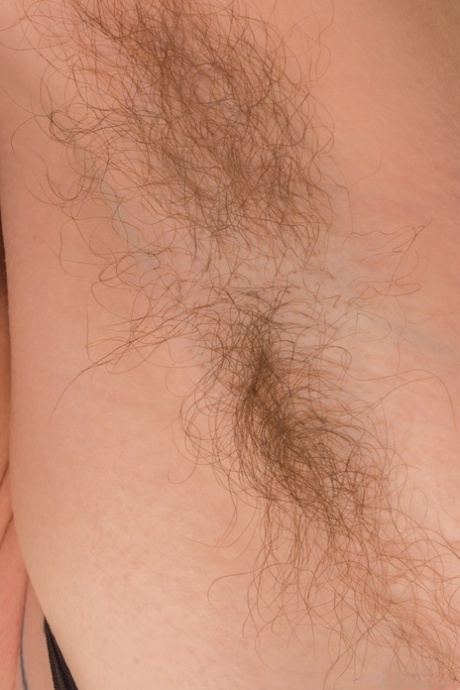 Mature with a hairy pussy Roxanne flaunts her bushy armpits outdoors