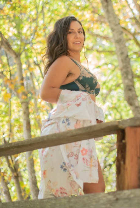 Brunette Nikki Silver strips in nature and shows her sexy curves & hairy body