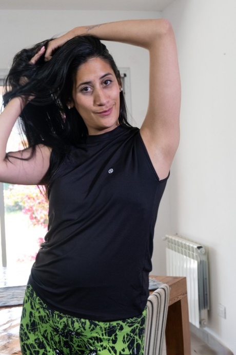 Exotic brunette Francesca spreading her furry pussy on the dining table